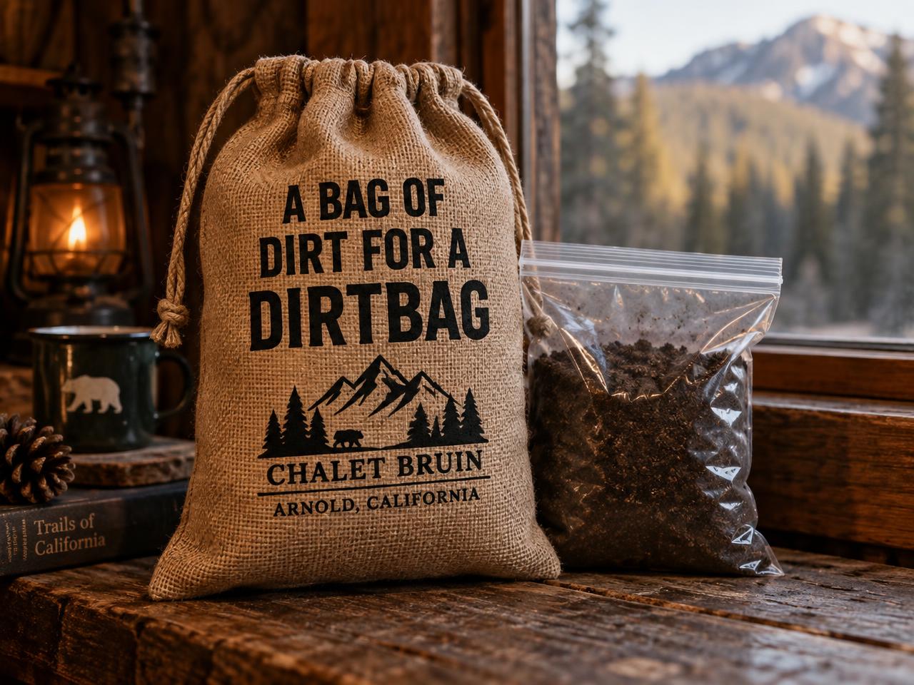 Burlap sack printed 'A bag of dirt for a dirtbag' beside a bag of soil on a cabin windowsill
