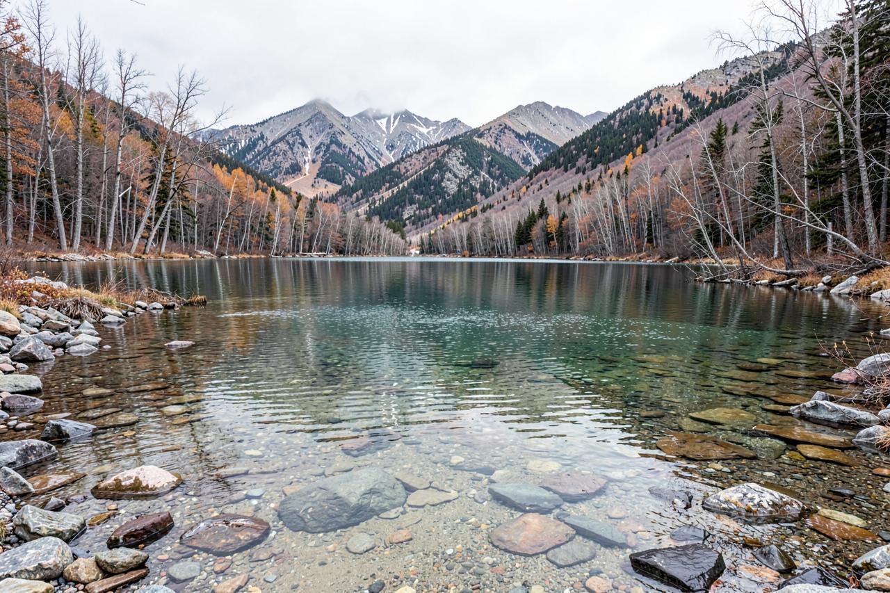 Pinecrest Lake in late autumn with the water drawn down, bare aspens and soft overcast light
